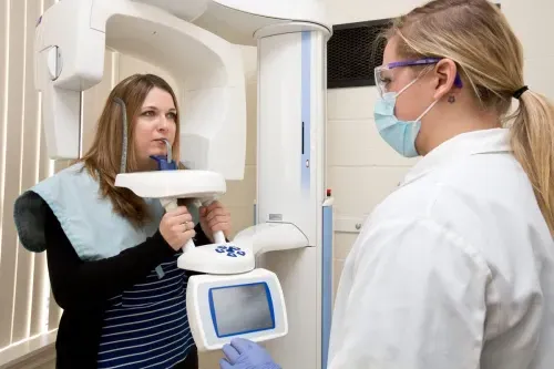 A dental hygiene student takes dental x-rays of a patient