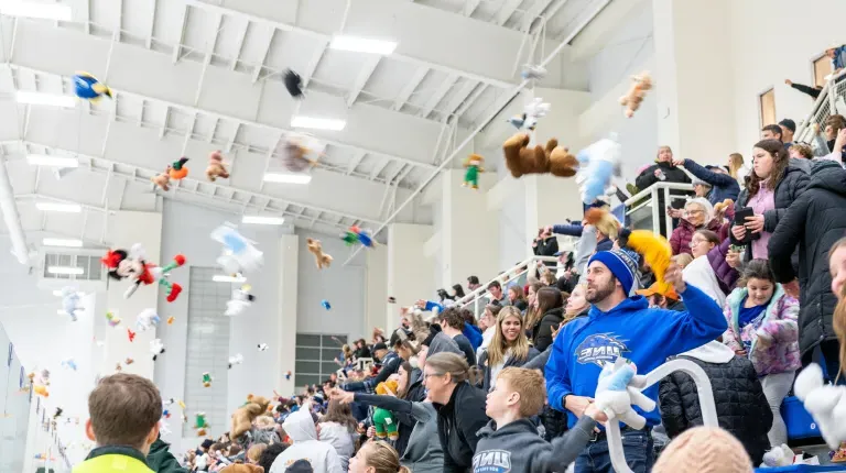 Spectators toss teddy bears onto the hockey ice