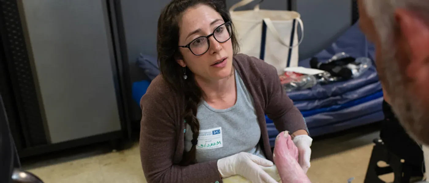 Health student assistants a patient at the foot clinic