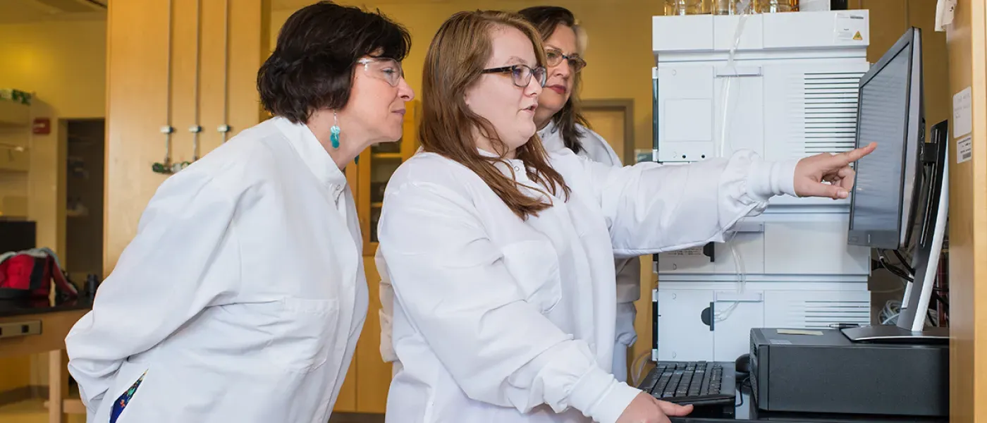 A student points to research data on a computer screen