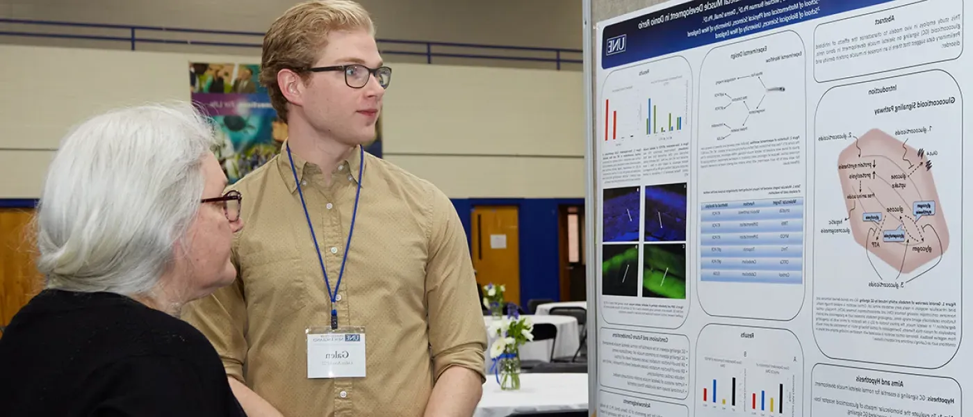 A student speaks about their poster presentation