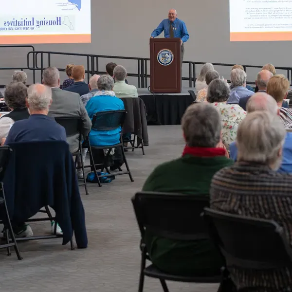 Tom Meuser speaks to an audience at a Legacy Scholars Breakfast for the Center of Excellence in Aging and Health