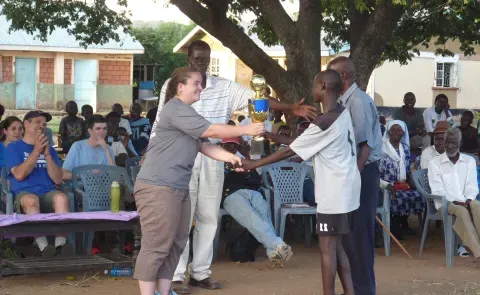 UNE students and Kenyan school children participating in NYADEC’s Football for the Environment program.