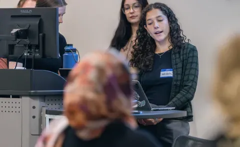 A group of students gives a slideshow presentation