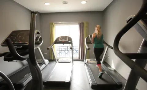 A woman runs on a treadmill